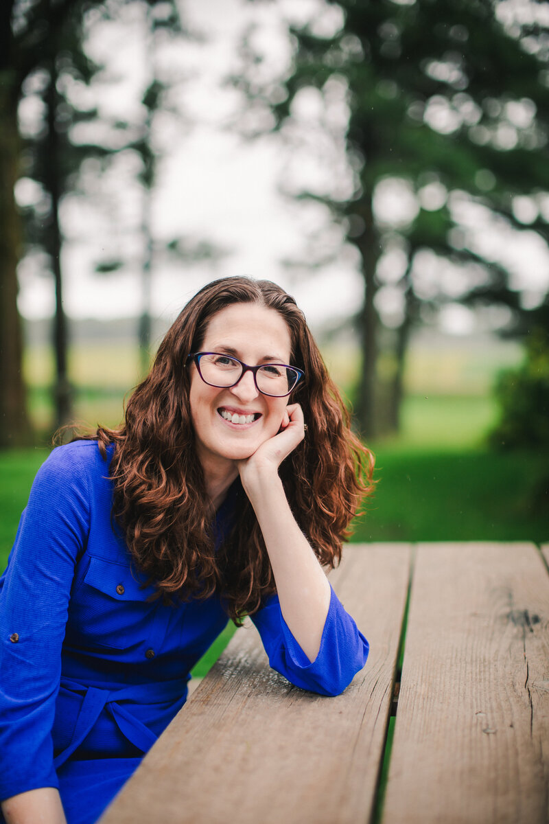 Woman smiling and holding a baby in her lap