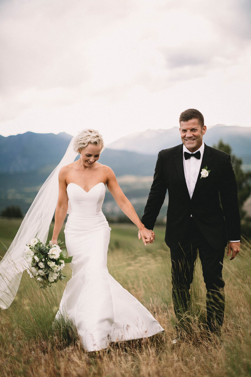 couple holding hands and smiling