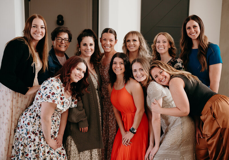 Andrea Wilde, founder and CEO of the LIVE BIG Collective leading a girls' night-- all women smiling