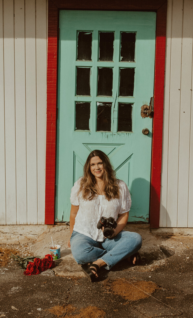 olivia sitting in front of door with camera and ice cream