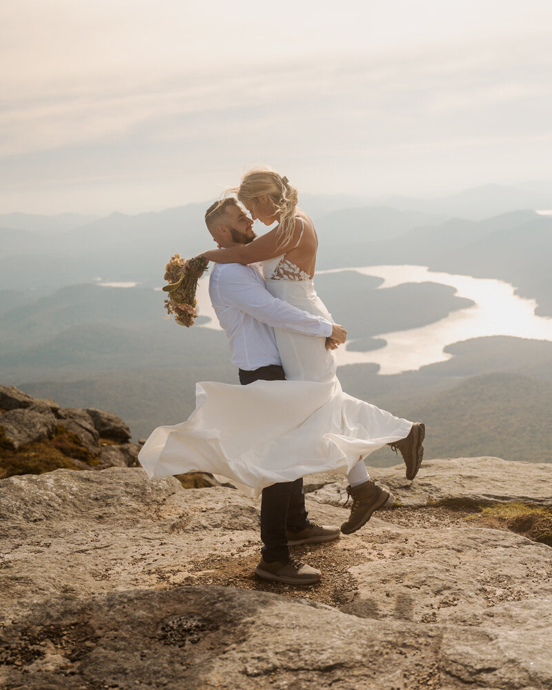 The bride and groom taking in the views of Lake Placid during their Whiteface Mountain elopement.