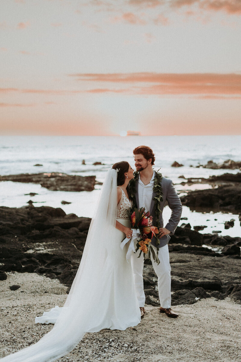 this is a photo of a couple getting married on a beach in Kailua Kona, Hawaii.