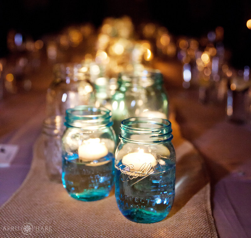 Blue-and-White-Mason-Jars-with-Floating-Candles-Lit-at-an-Evening-Reception-From-Cowboy-Gourmet-Events-in-Vail-Colorado