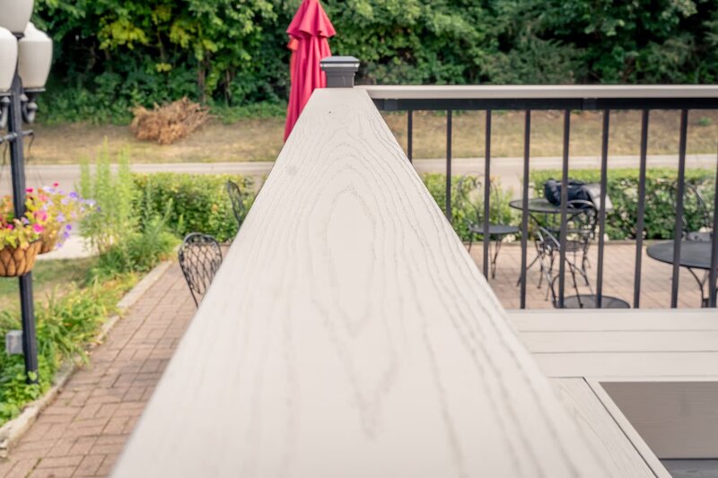 Close-up view of TimberTech Advanced PVC drink rail in the color Slate Gray. 