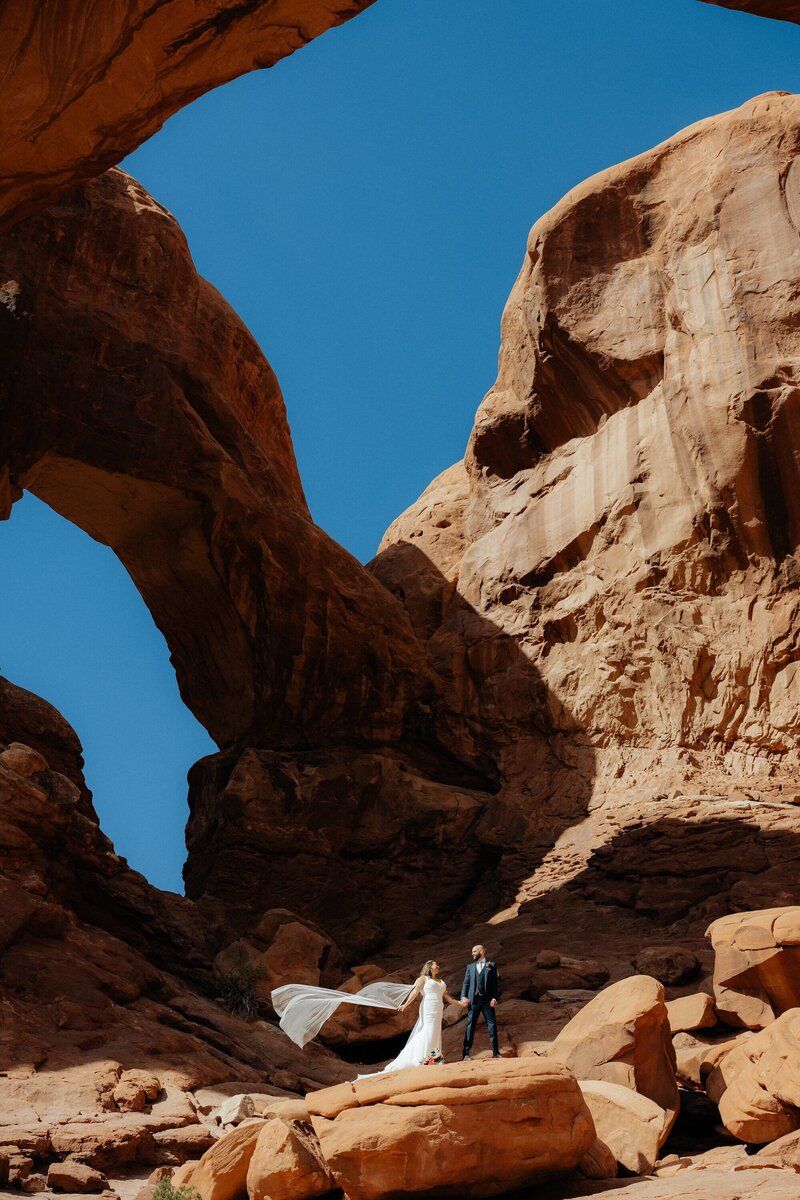 Candid moment of a couple eloping in Utah’s mountains, taken by an adventure elopement photographer