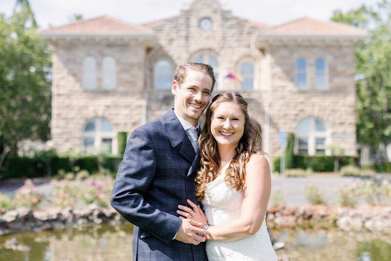 bay area photographers captures bride and groom wedding portrait in front of a stone wedding venue for a California wedding