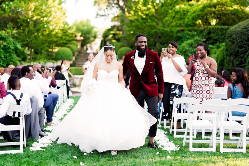 Swank Soiree Dallas Wedding Planner Kerri and Bravion at the Dallas Arboretum and Botanical Garden - Bride and Groom walking down the aisle