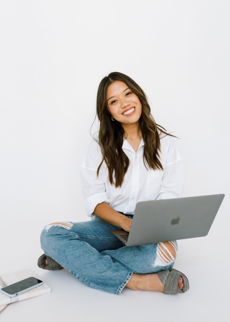 Woman smiling with computer in hand