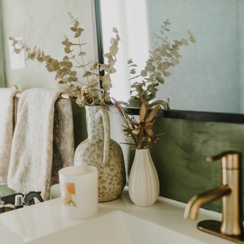 Bathroom sink with candle and decorative plants