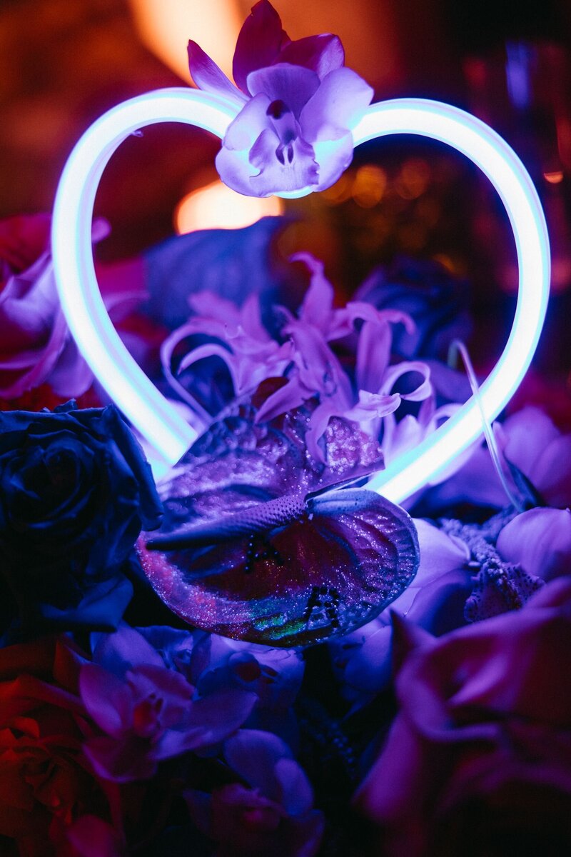 A woman resting one hand on a dresser.