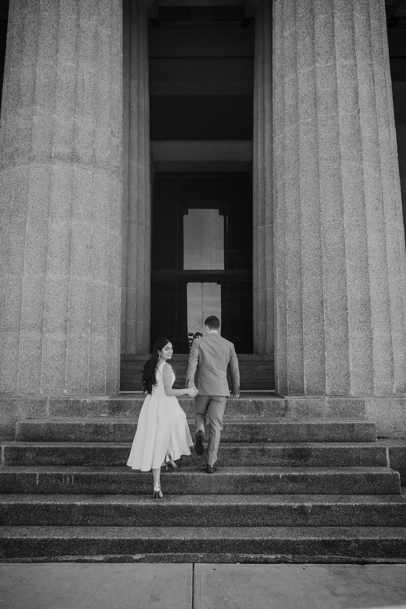 Bride and groom walk up memorial steps at their DC wedding