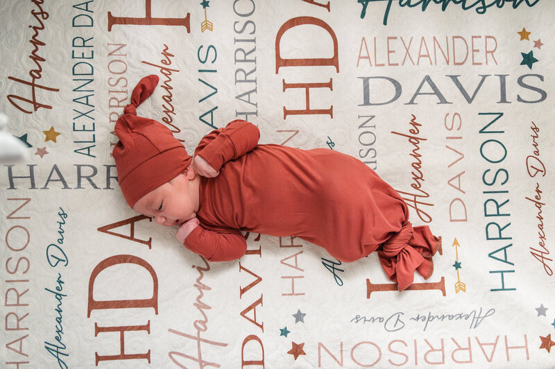 baby boy laying in crib by newborn photographer baltimore md