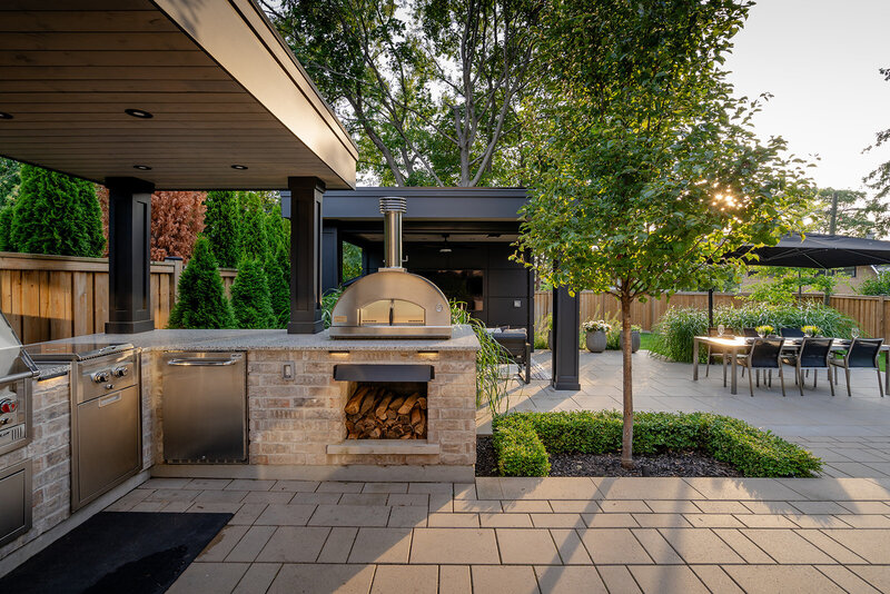 outdoor kitchen in the backyard with a woodstove oven