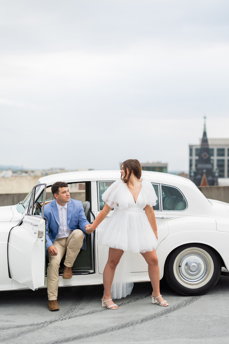 Couple posing with vintage car at Alabama engagement photo session