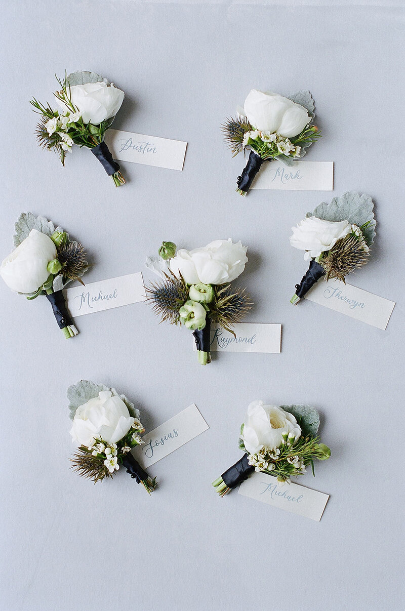 8-radiant-love-event-flatlay-7-mini-white-flower-bouquet-escort-tags-romantic-elegant-timeless