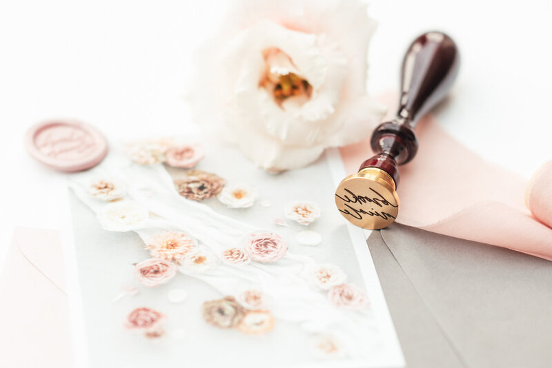 Gold wax stamp with signature and flowers for luxury brand design for wedding planner