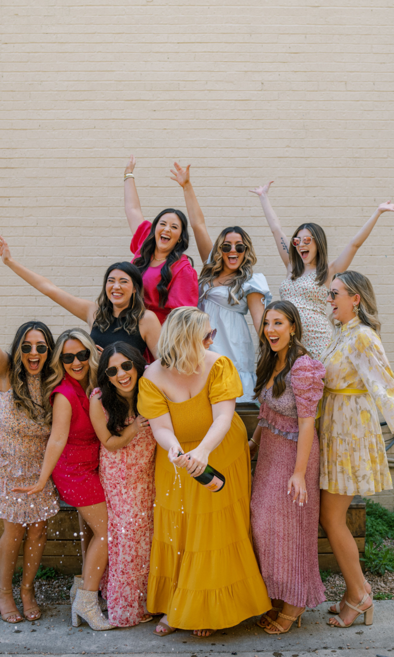 Wedding planner pops a bottle of champagne with her team