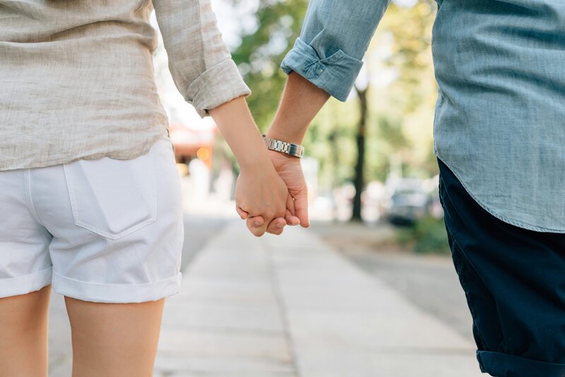 a man and woman holding hands