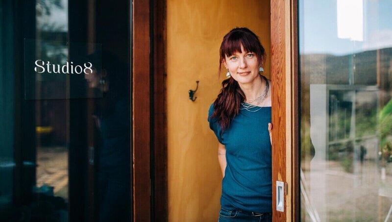 Sara standing in doorway smiling