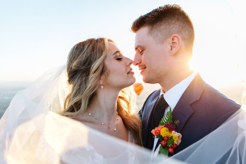 golden hour of sun peaking through the middle of a married couple Oregon Coast Elopement and Wedding Photographer