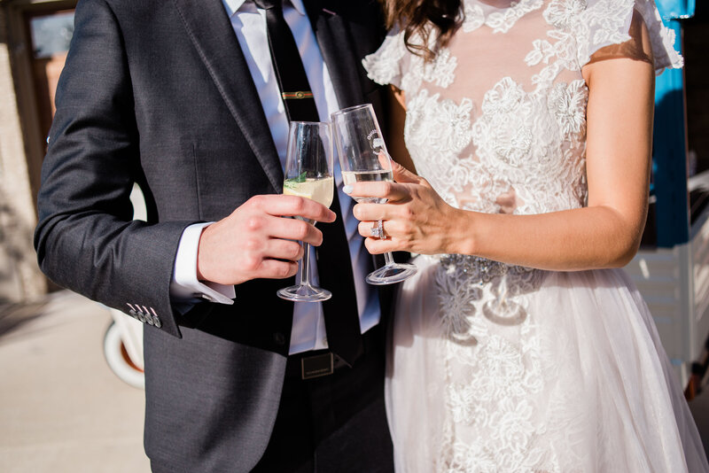 Couple with champagne in front of mobile bar cart