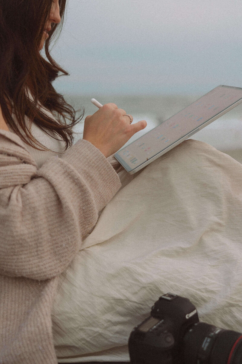 private photo editor sitting and editing on ipad
