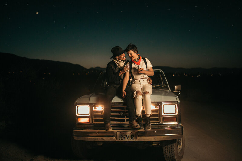 couple holding each other on a car