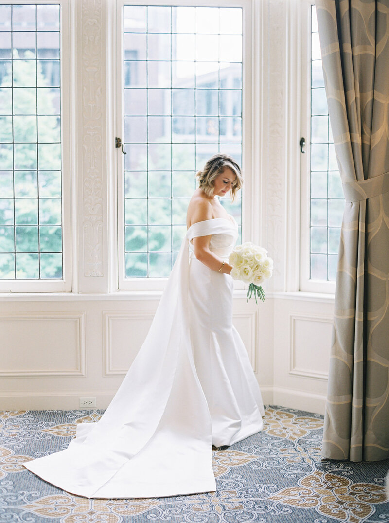 seattle wedding photographers bride standing in front of window in The Rainier club