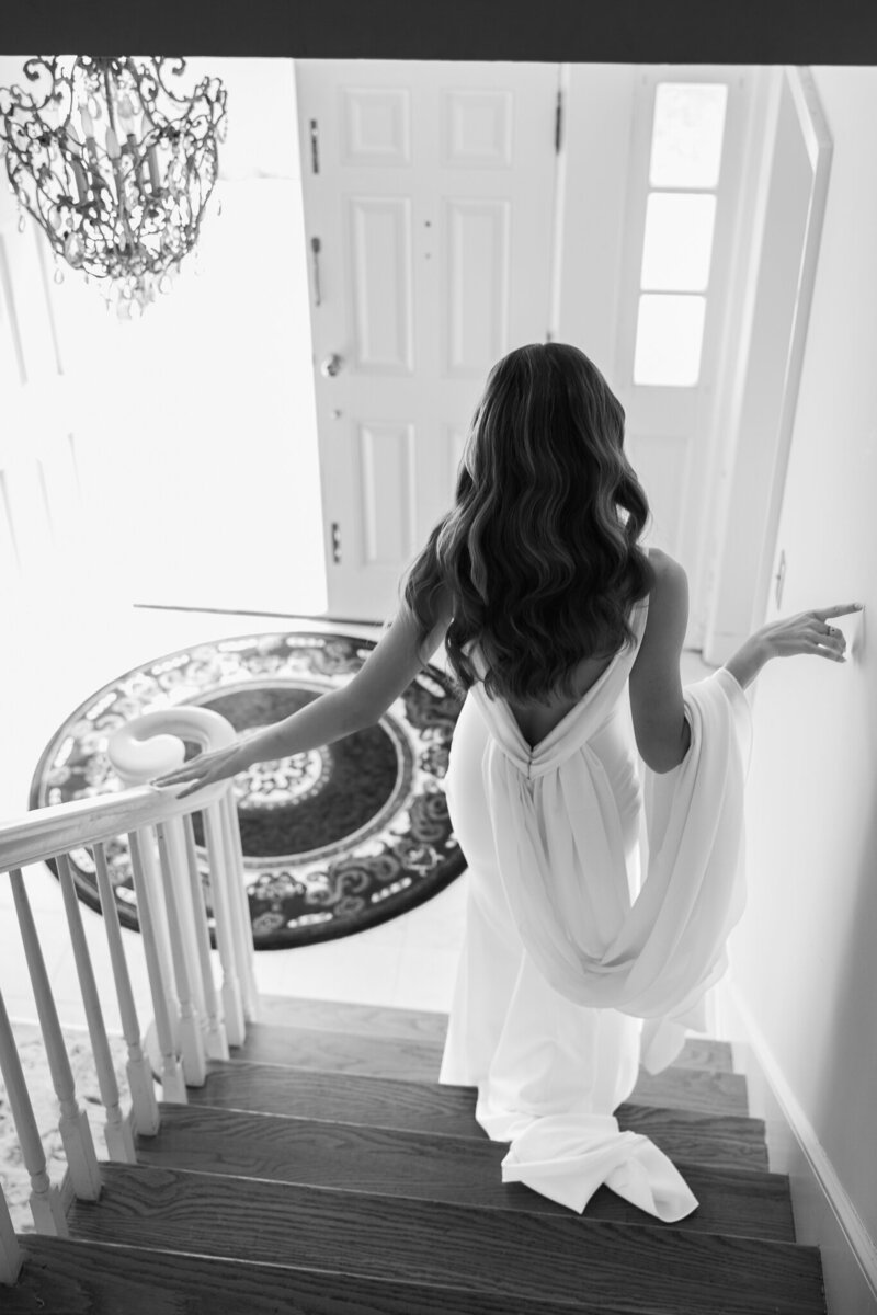 bride walking down a set of stairs from behind
