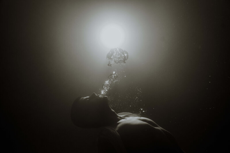 black and white portrait of man underwater
