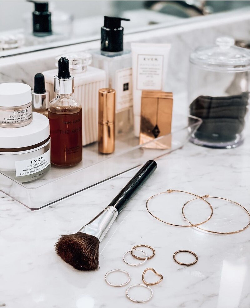 photo of beauty products, makeup brush and earrings by AMALYN @amalynsocial and @amalynstyle 