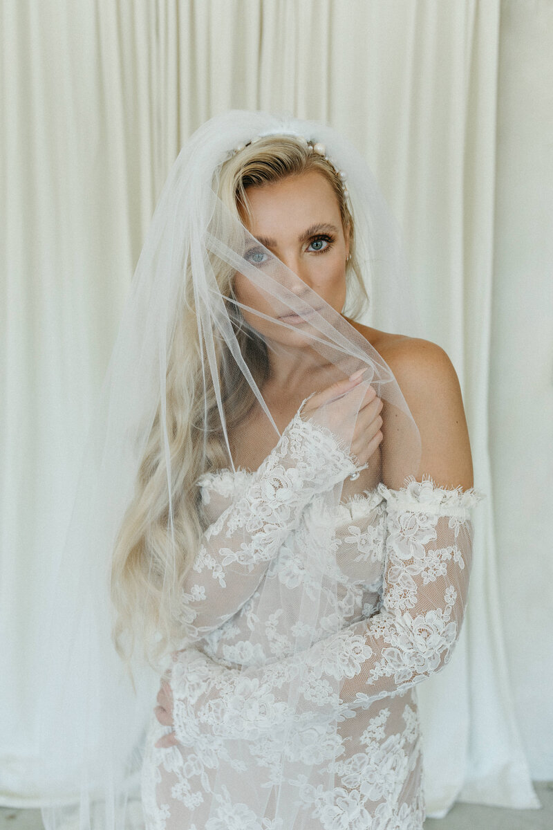 editorial bride wearing a veil and lace dress