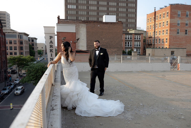 Bride and groom on roof of a building in a city