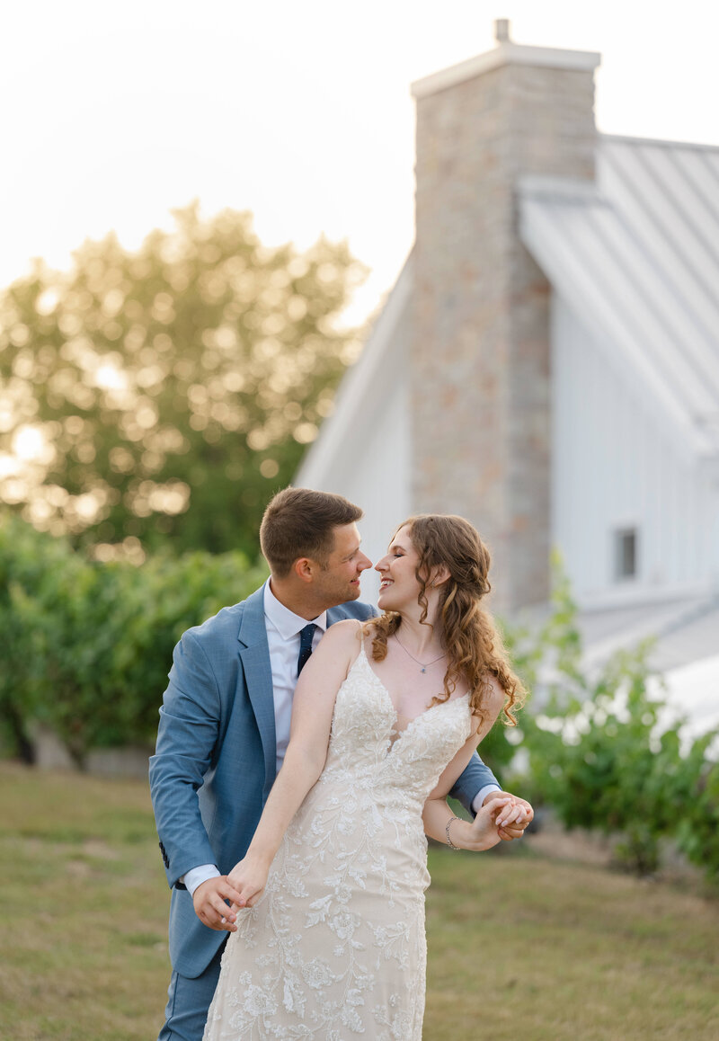 A bride and groom at their wedding in Traverse City in a vineyard by a Michigan wedding photographer