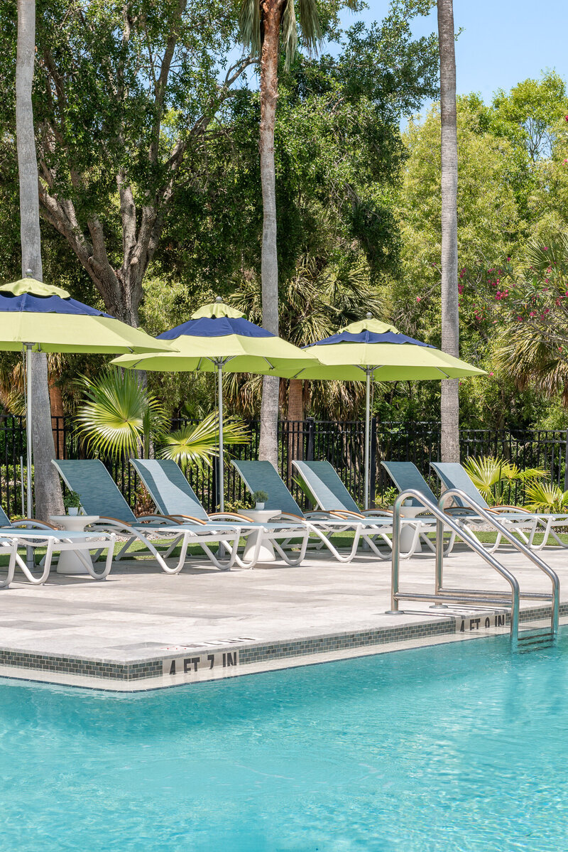 Commercial interior design for a beautiful outdoor pool area with string lights and plenty of seating. Commercial design by Gracious Home Interiors, luxury interior design in Waxhaw NC and across the east coast.