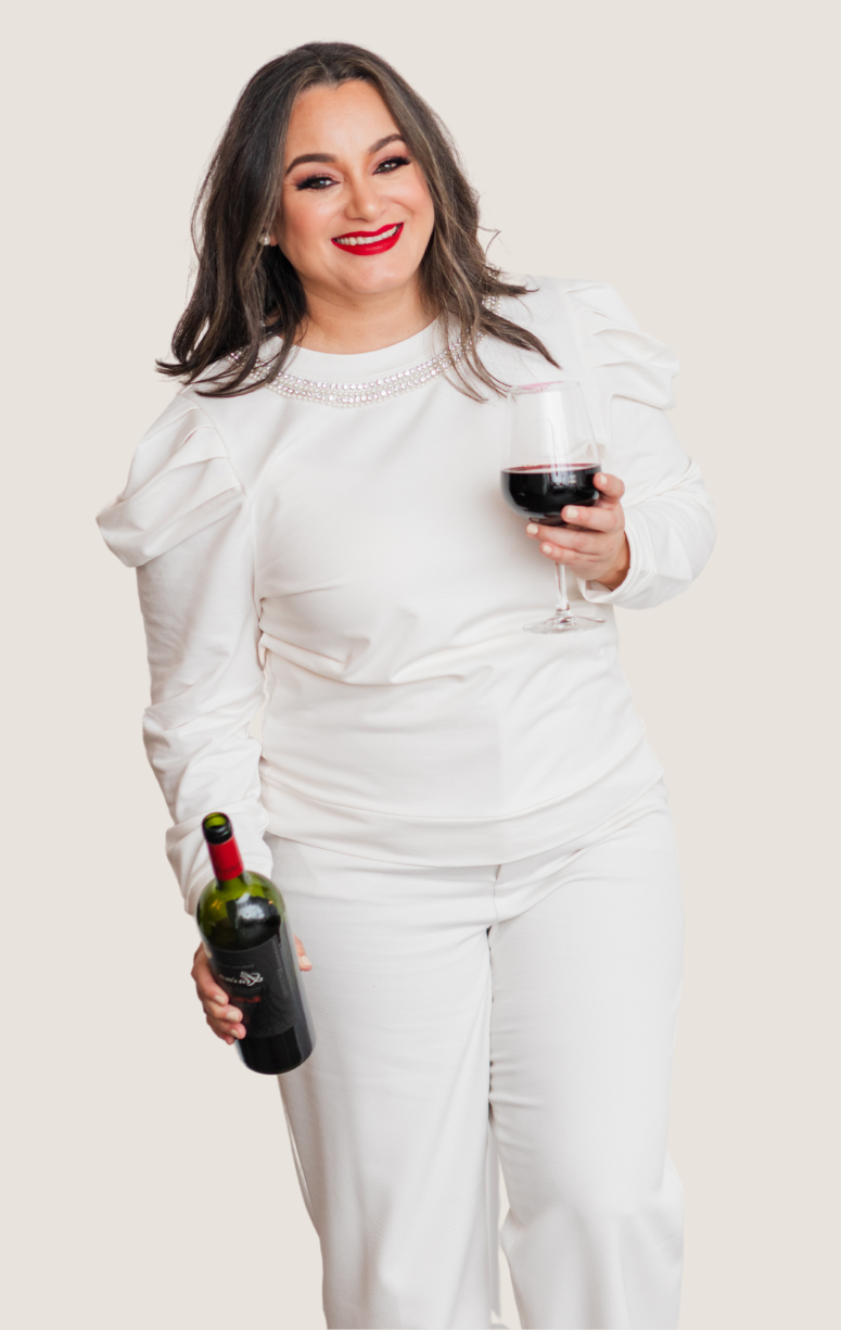 Owner of Tinted Events smiling and holding a glass of wine