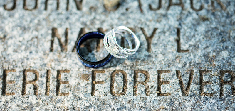 Photo of wedding rings on a concrete monument at Presque Isle State Park