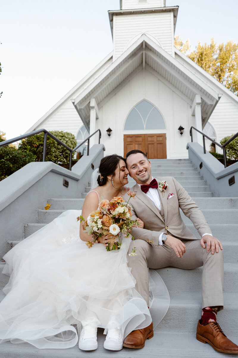 bride and groom kissing with confetti