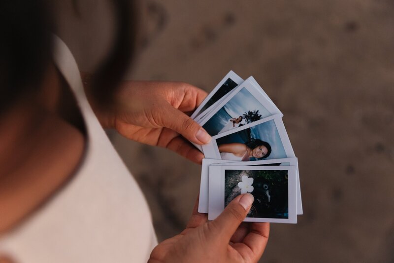 Detail photo of Amber's hands holding her film fanned out.