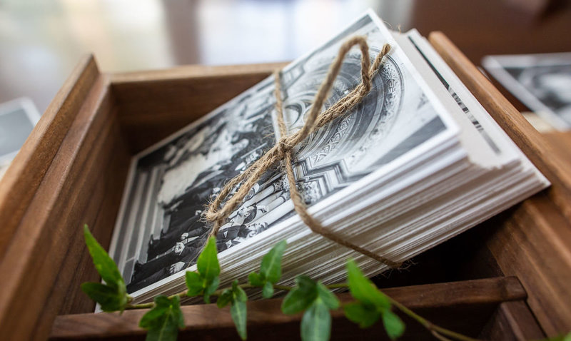 A close up of fine-art prints inside wooden keepsake box.
