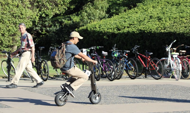 College student riding to class on grey Go-Bike M2