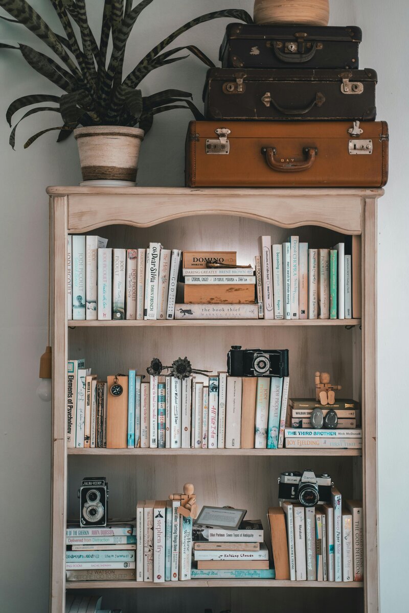 Grand historic library with floor-to-ceiling bookshelves, ornate staircase, and detailed molding, reflecting a deep tradition of literature, copy editing, and professional proofreading services.