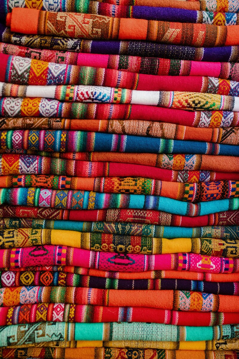 Colorful folded textiles reflecting ancestral wisdom, Latin American heritage, and healing through story