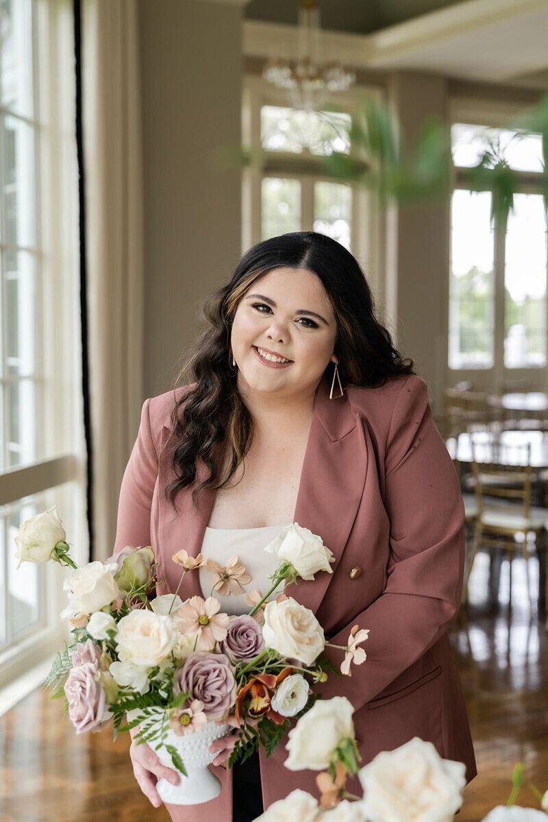 Grow your wedding business, florist student posing with florals
