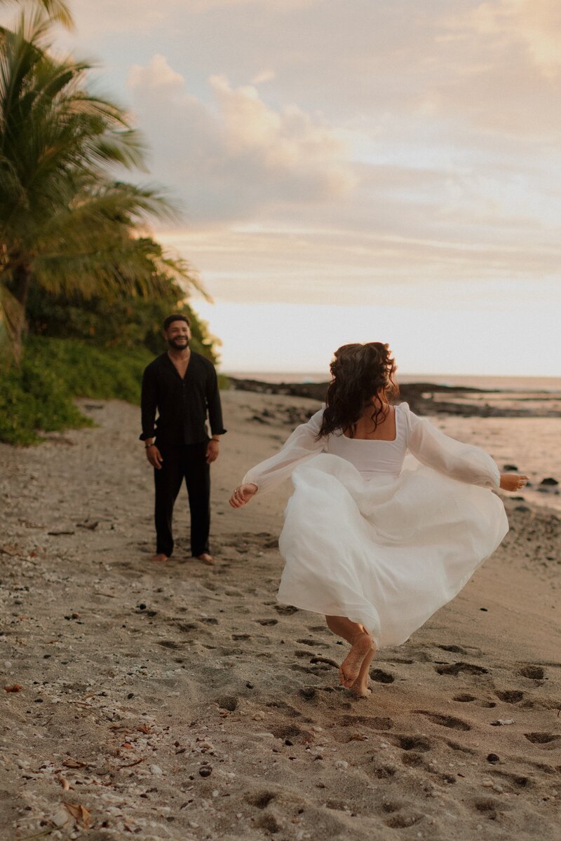 bridge running to groom on beach in hawaii