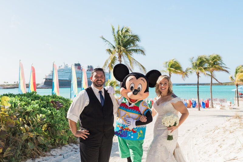 Disney cruise wedding couple smiling with Mickey Mouse