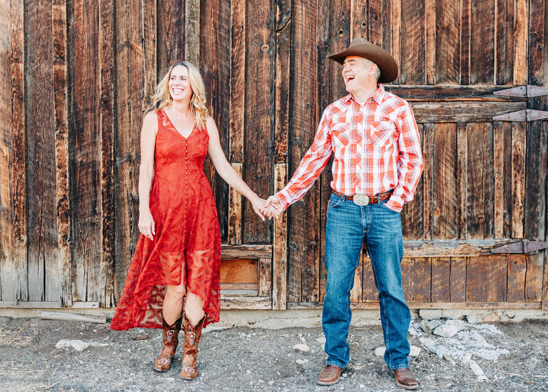 Western Montana couple holding hands and smiling at Travelers Rest State Park in Lolo, MT
