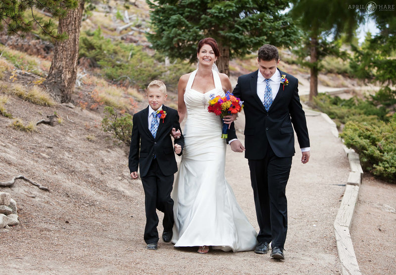 Bride walks down trail aisle at Sapphire Point in Summit County