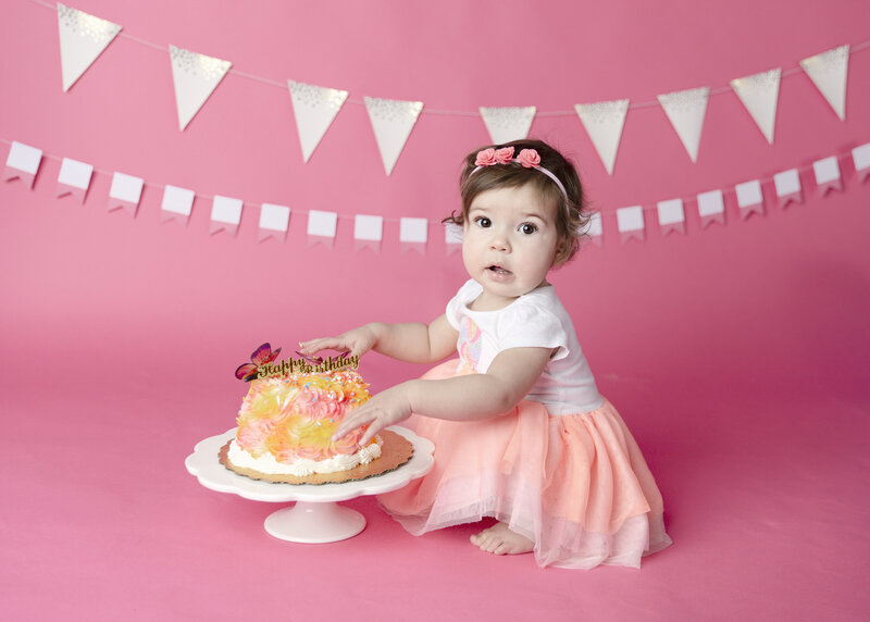 Baby girl eating a cake