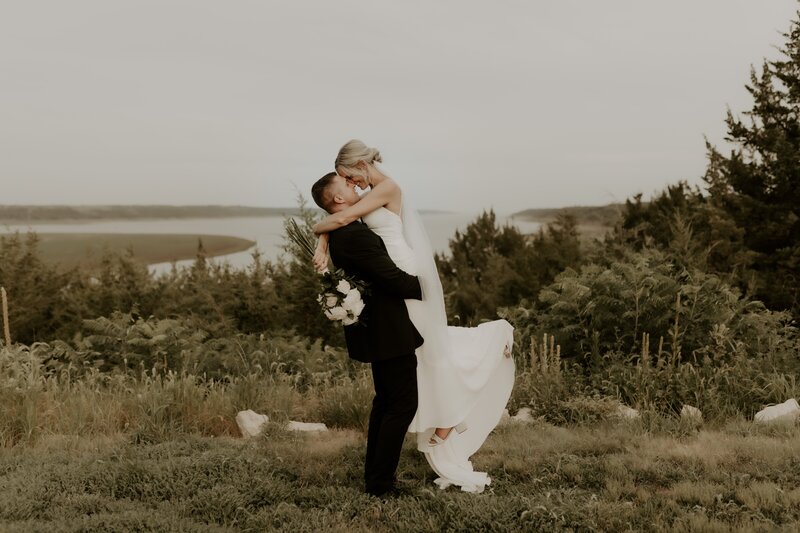 groom picking bride up off her feet